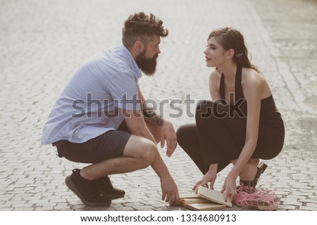 Love at first sight. Man and woman falling in love. Bearded man and cute woman met on street. Hipster helping and looking at pretty girl. Couple in love on summer day. Enjoy romantic date and dating. Royalty-Free Stock Photo #1334680913