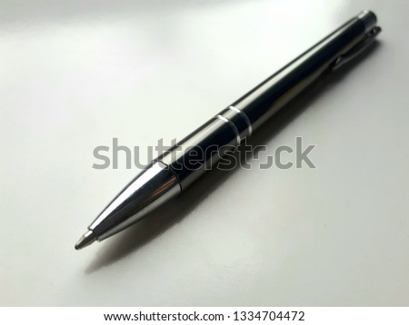 Black shiny ballpoint pen on white background