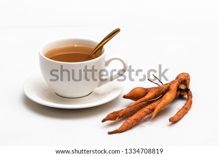 The finger root or Chinese's Ginger is herbal beverage in thailand. white cup and golden spoon with herb in picture.