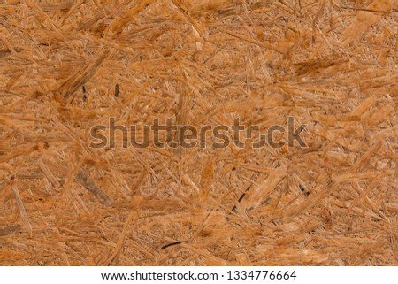 A horizontal texture of yellow chipboard for construction with knots
