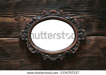 Vintage photo frame border with a copy space on a wooden wall background.