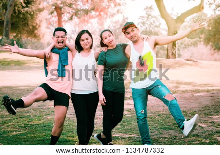 Group of happy millennials enjoying their time in the park.-Group of teenagers making funny faces for a photo.