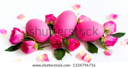 Pink Easter eggs on light background with  pink roses. Long wide banner with copy space.