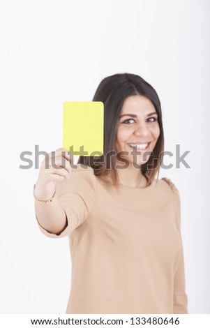 woman showing yellow card as as symbol for warning and/or negative expression.