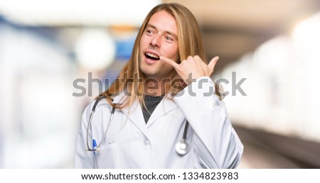 Doctor man making phone gesture. Call me back sign in a hospital