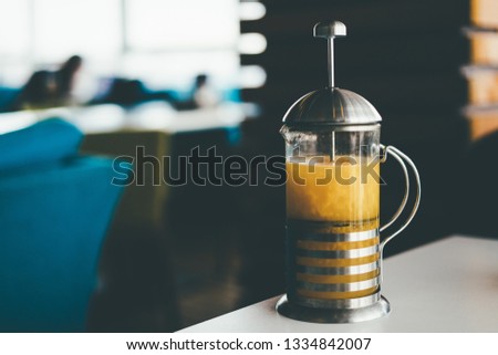 teapot with sea buckthorn tea on the table
