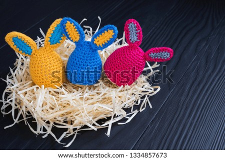 Cute creative photo with eggs as the Easter Bunny on a wooden background.