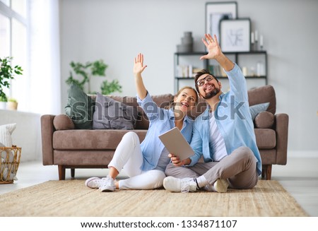 concept of moving, buying  home.  young married couple plans to repair and a project apartment Royalty-Free Stock Photo #1334871107