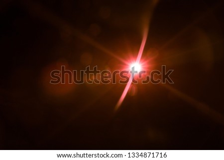 abstract lens flare red light over black