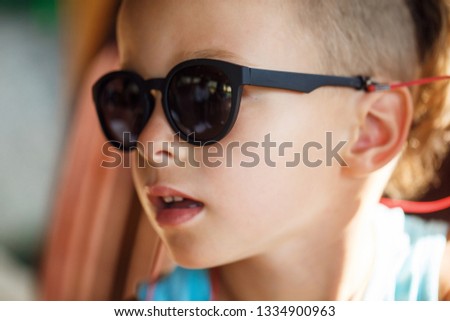 Portrait of a beautiful baby boy in sunglasses in Thailand 