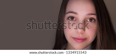 Portrait of beautiful teen girl looking at camera