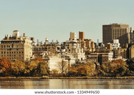 Central park Manhattan east side luxury building over lake in Autumn in New York City.