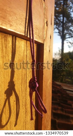 the rope hangs on the door