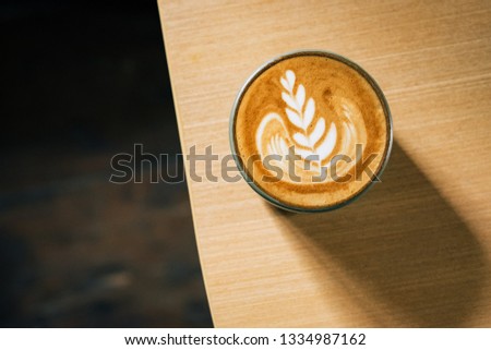 top view cup of hot latte coffee on wood table