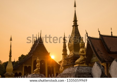 Beautiful sunset with old temple in Luang Prabang the UNESCO world heritage town in north central of Laos.