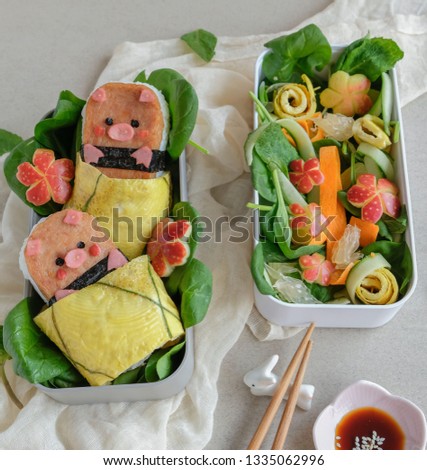 Popular Japanese American snack in Hawaii / Animated Shaped Luncheon Musubi Bento with Salad / Homemade take away meal in bento boxes, ideal for working people and full of nutritional value 