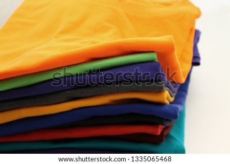 Colorful folded t shirt background 