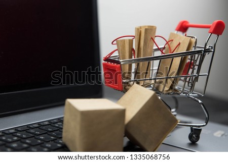 Shopping cart with purchases - packages and boxes. Online shopping and sale concept.