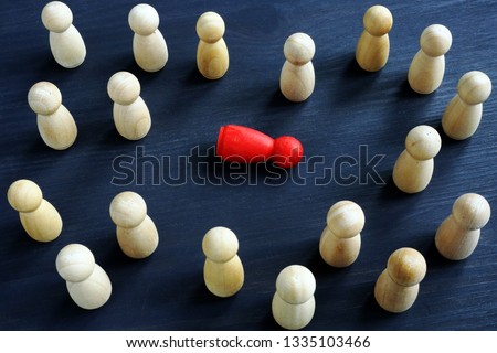 Bullying, workplace harass and loneliness concept. Wooden figurines on a desk. Royalty-Free Stock Photo #1335103466