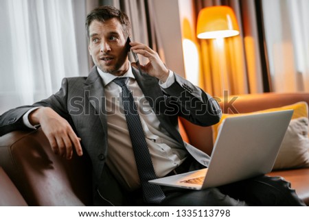 Businessman on the phone at a hotel room. Executive manager talking on the phone.