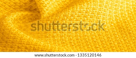 Background texture, pattern. Yellow fabric with metallic sequins. This beautiful lightweight sequined fabric has notes, sequined accents and a beautiful design. It also has a nice sheen.