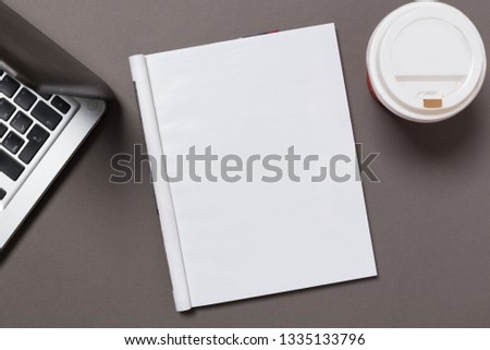 office desk top view with blank notebook  isolated on gray, with clipping path, changeable background. Blank page or notepad on wood background. Blank page or notepad for mockups or simulations. 