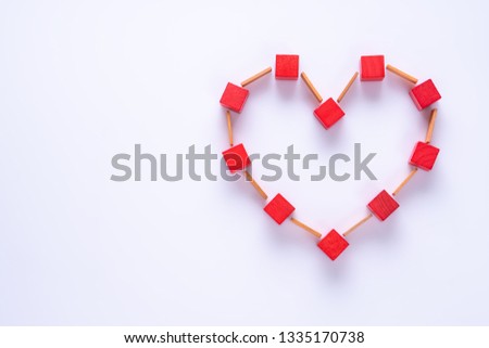 Heart made of colorful wooden shapes, top view, flat lay. Health background concept. Abstract red heart.