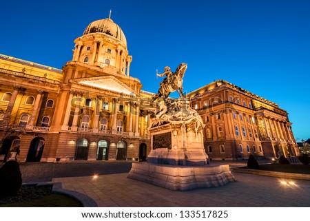 The illuminated main facade of the historic Royal Palace - Buda Castle in Budapest with the statue of Savoyai Eugen - Hungary at night Royalty-Free Stock Photo #133517825