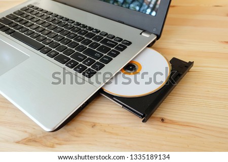 CD DVD Drive Writer Burner Reader internal of laptop computer on wooden background