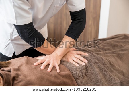 The woman who receives chiropractic treatment Royalty-Free Stock Photo #1335218231