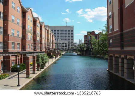 Canal Walk in Indianapolis, Indiana, USA. It is located in the downtown. Beautiful buildings line along the river. Blue sky and clean water in summer. 