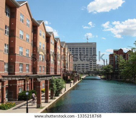 Canal Walk in Indianapolis, Indiana, USA. It is located in the downtown. Beautiful buildings line along the river. Blue sky and clean water in summer. 