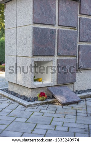 A stone columbarium with an empty niche and without an urn