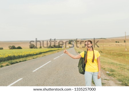 Student girl hitchhiking around Europe