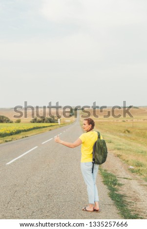 Student girl hitchhiking around Europe