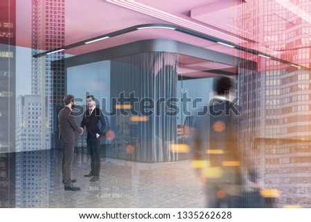 Businessmen in corner of office meeting room with gray and glass walls, concrete floor, pink ceiling and long black table with chairs. Toned image double exposure blurred