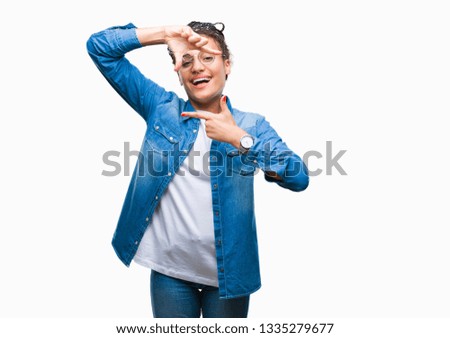 Young braided hair african american girl wearing glasses over isolated background smiling making frame with hands and fingers with happy face. Creativity and photography concept.
