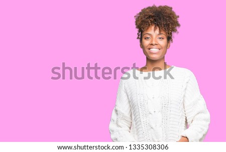 Beautiful young african american woman wearing winter sweater over isolated background Hands together and fingers crossed smiling relaxed and cheerful. Success and optimistic