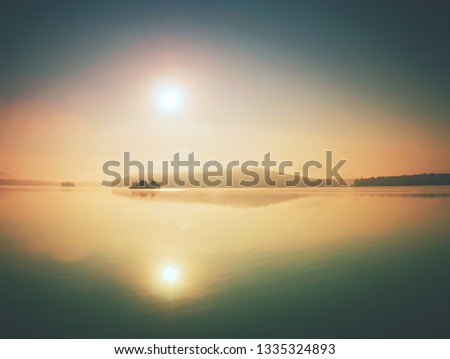 Beautiful sunset. Romantic sunset on the lake. Evening landscape. Clouds reflected in the water. The horizon at sunset. Sea, lake at sunset. The waves on the river.