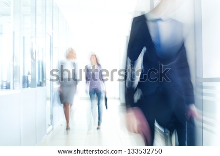 businesspeople walking in the corridor of an business center, pronounced motion blur Royalty-Free Stock Photo #133532750