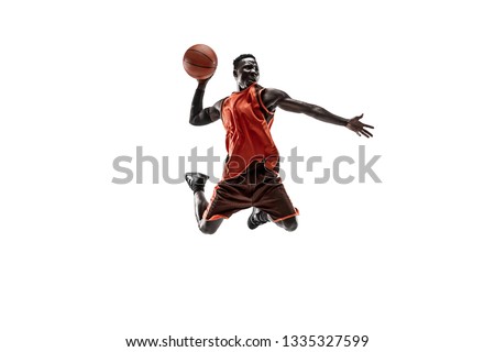 Full length portrait of a basketball player with a ball isolated on white studio background. advertising concept. Fit african american athlete jumping with ball. Motion, activity, movement concepts. Royalty-Free Stock Photo #1335327599