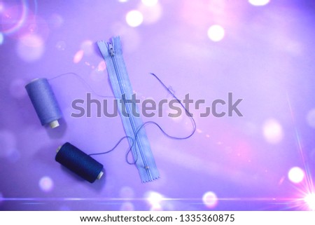 beautiful bright minimal urban girly colorful flat lay top view close up photo of accessories for sewing, zipper, thread on clean background with copy space and retro magical old school light effect