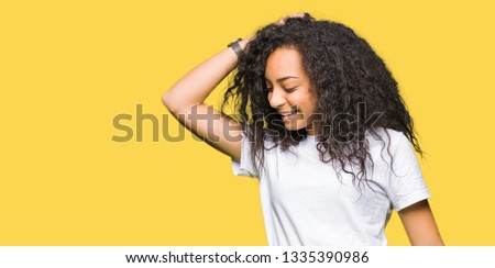 Young beautiful girl with curly hair wearing casual white t-shirt Dancing happy and cheerful, smiling moving casual and confident listening to music