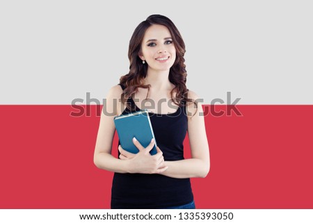 Happy girl on the Poland flag background. Travel and learn polish language concept Royalty-Free Stock Photo #1335393050