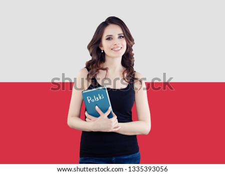 Pretty smiling woman with book on the Poland flag background. Travel and learn polish language concept Royalty-Free Stock Photo #1335393056