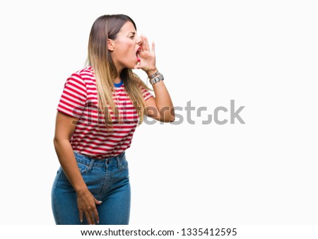 Young beautiful woman casual look over isolated background shouting and screaming loud to side with hand on mouth. Communication concept.