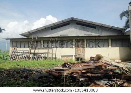 old warehouse and pile of wooden garbage