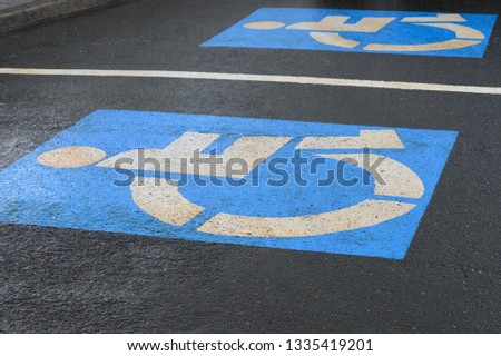 sign parking for disabled on asphalt, close-up