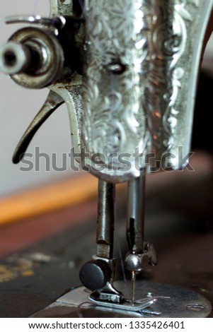 Classic retro style manual sewing machine ready for sewing work, close up photo