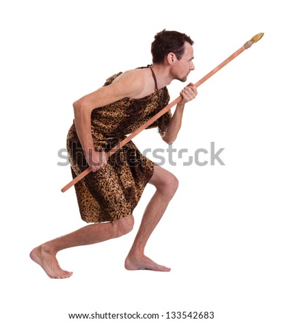 Following man as a savage hunter in skin of a beast with spear isolated on white background